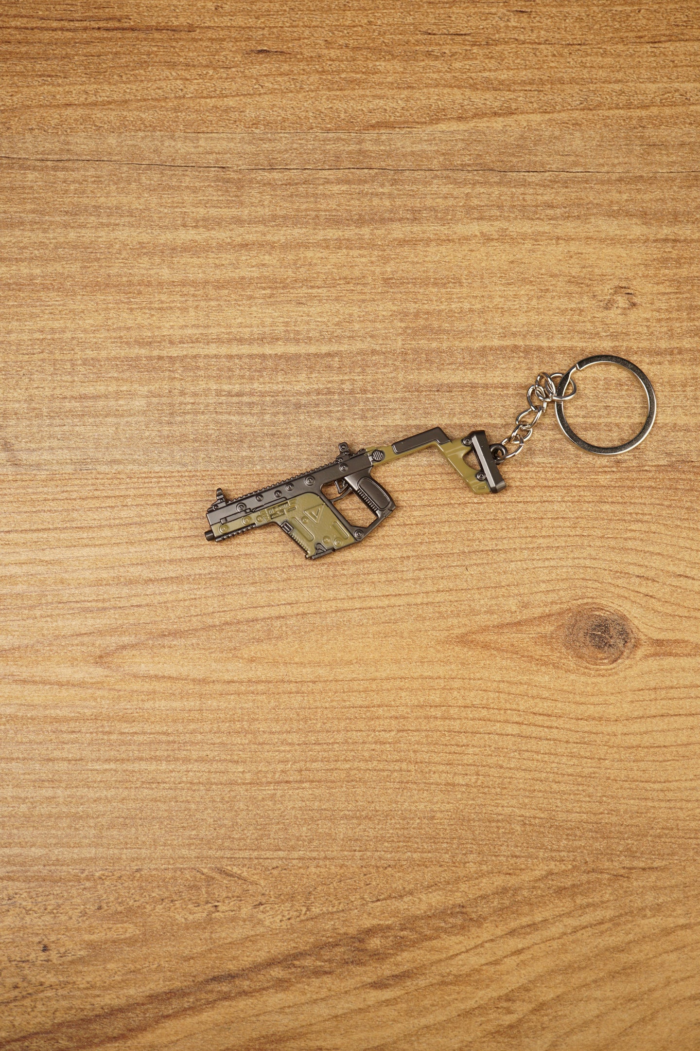 Side view of KRISS Vector Gen 2 inspired gun keychain with metal ring and chain, perfect for backpacks, keys and gaming setups