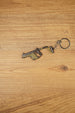 Side view of KRISS Vector Gen 2 inspired gun keychain with metal ring and chain, perfect for backpacks, keys and gaming setups