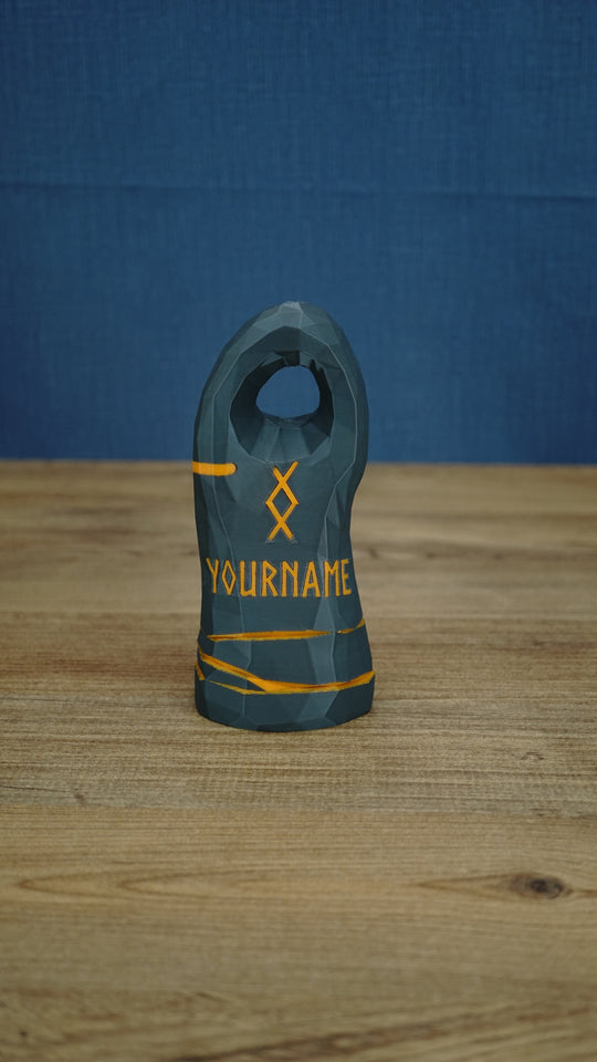 Large dark gray Valheim-inspired tombstone with a circular top cutout, orange rune symbol, YOURNAME text, and painted orange band details.