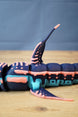 Detailed side close-up of Marrowbreach inspired figure showing dorsal fin, fins, body segments, coral red stripes and light blue lower panels.