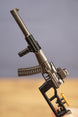 Close-up of modded VSS style rifle keychain with suppressor, rail detail, curved magazine and tactical stock