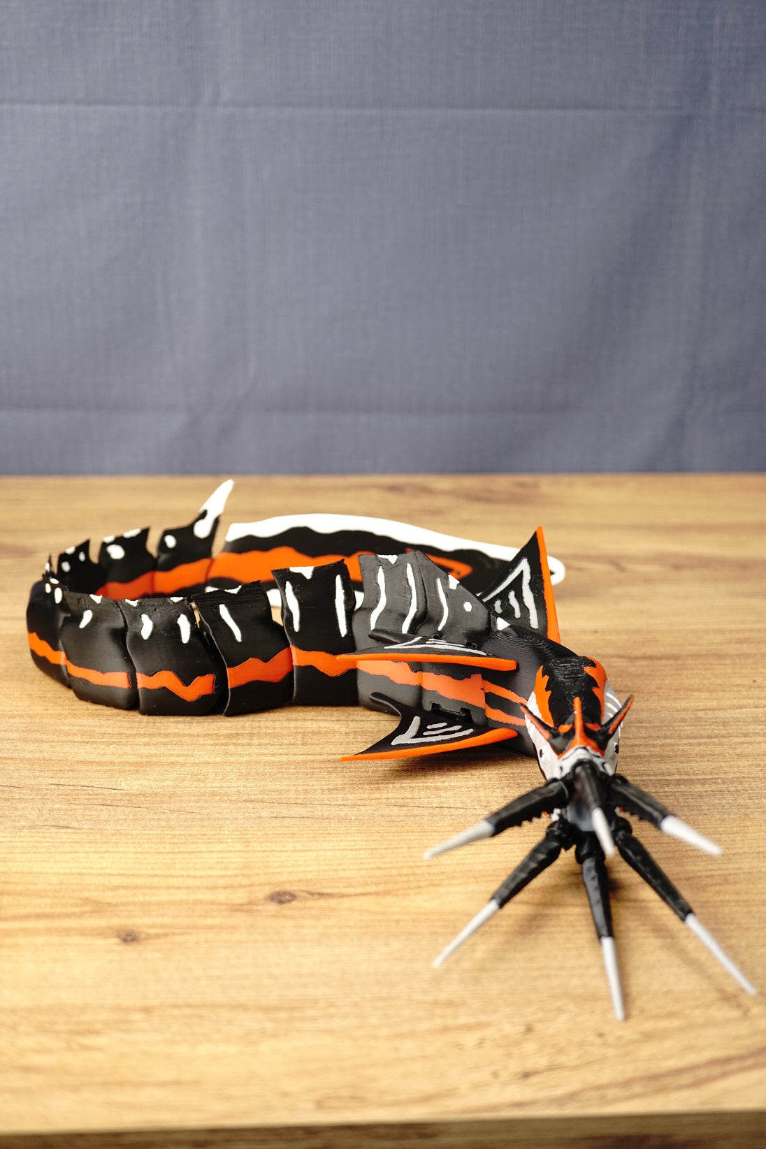 Large articulated Needler Mango model curved into a swimming pose, displaying its segmented body, detailed head, multiple fins and extended tusks.