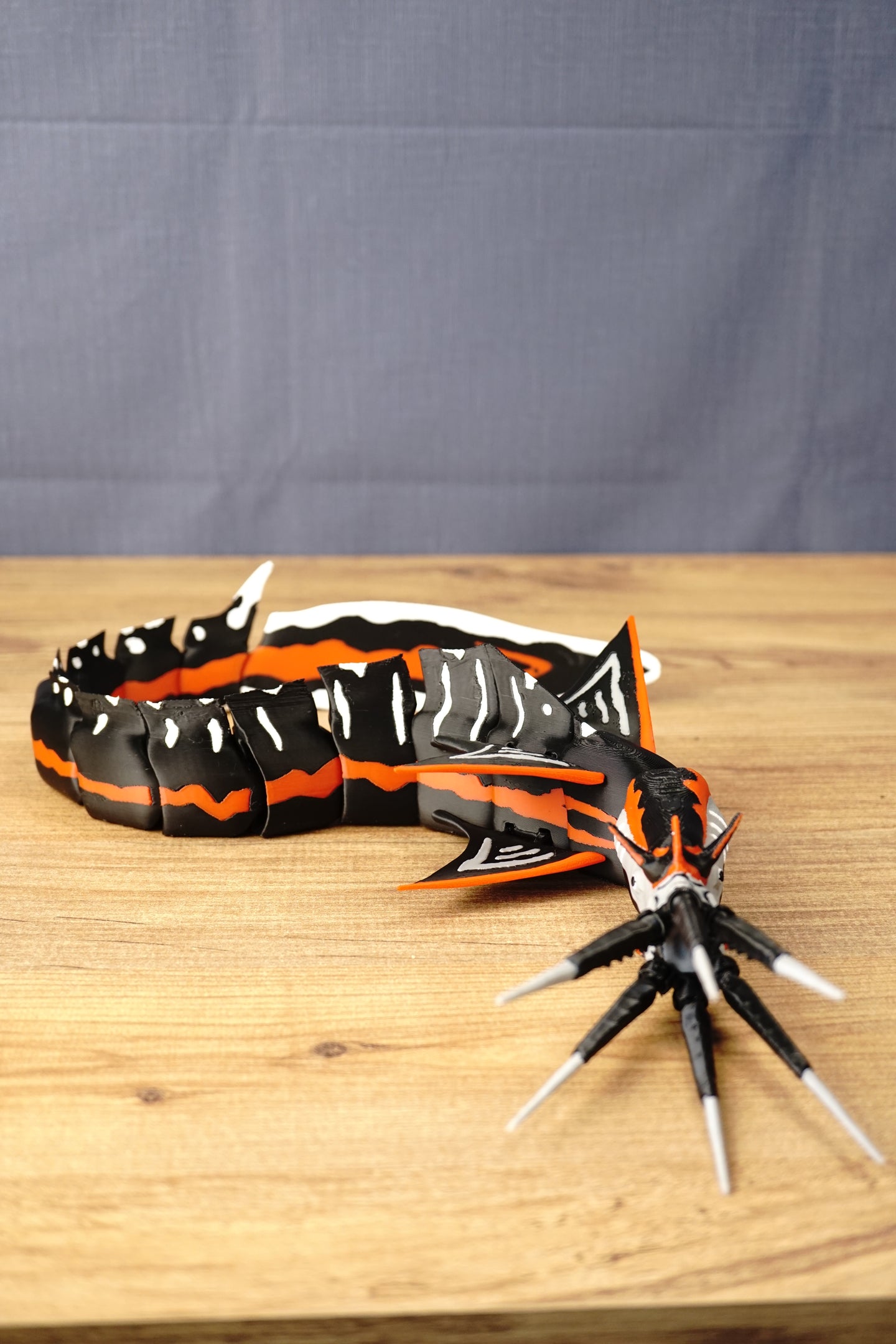 Large articulated Needler Mango model curved into a swimming pose, displaying its segmented body, detailed head, multiple fins and extended tusks.