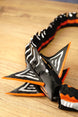 Close-up of the Needler Mango model’s layered fins, featuring black surfaces, white patterns and bright orange edges beside the segmented body.