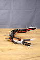 Side view of the Needler Mango collectible with its long flexible body, open needle-like mouth, black fins and bold orange, red and white markings.