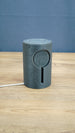 No Man’s Sky inspired Knowledge Stone LED light shown unlit on a wooden desk, featuring a dark grey sci-fi cylindrical body and engraved alien details.