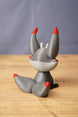Rear view of Obsidian Kitsuu figure showing grey curled tail, red tail tip, tall ears and white back head detail