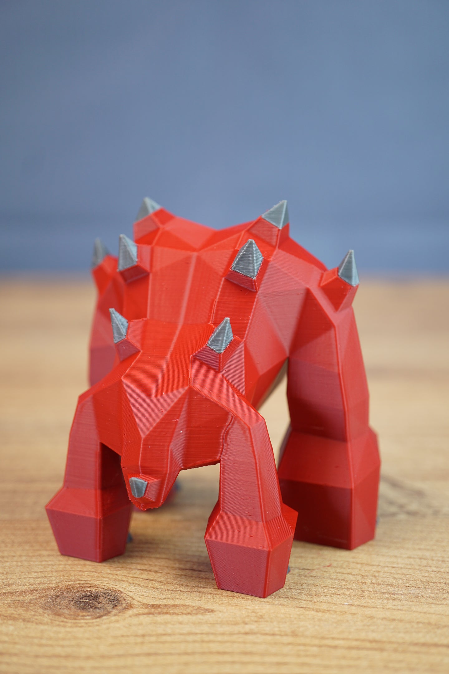 Stylized red demon monster collectible with polygon design