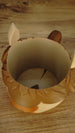 Top-down view inside the empty Ormuu Shack ice cream holder, showing its smooth cream interior, circular base and wide opening for a packaged tub.