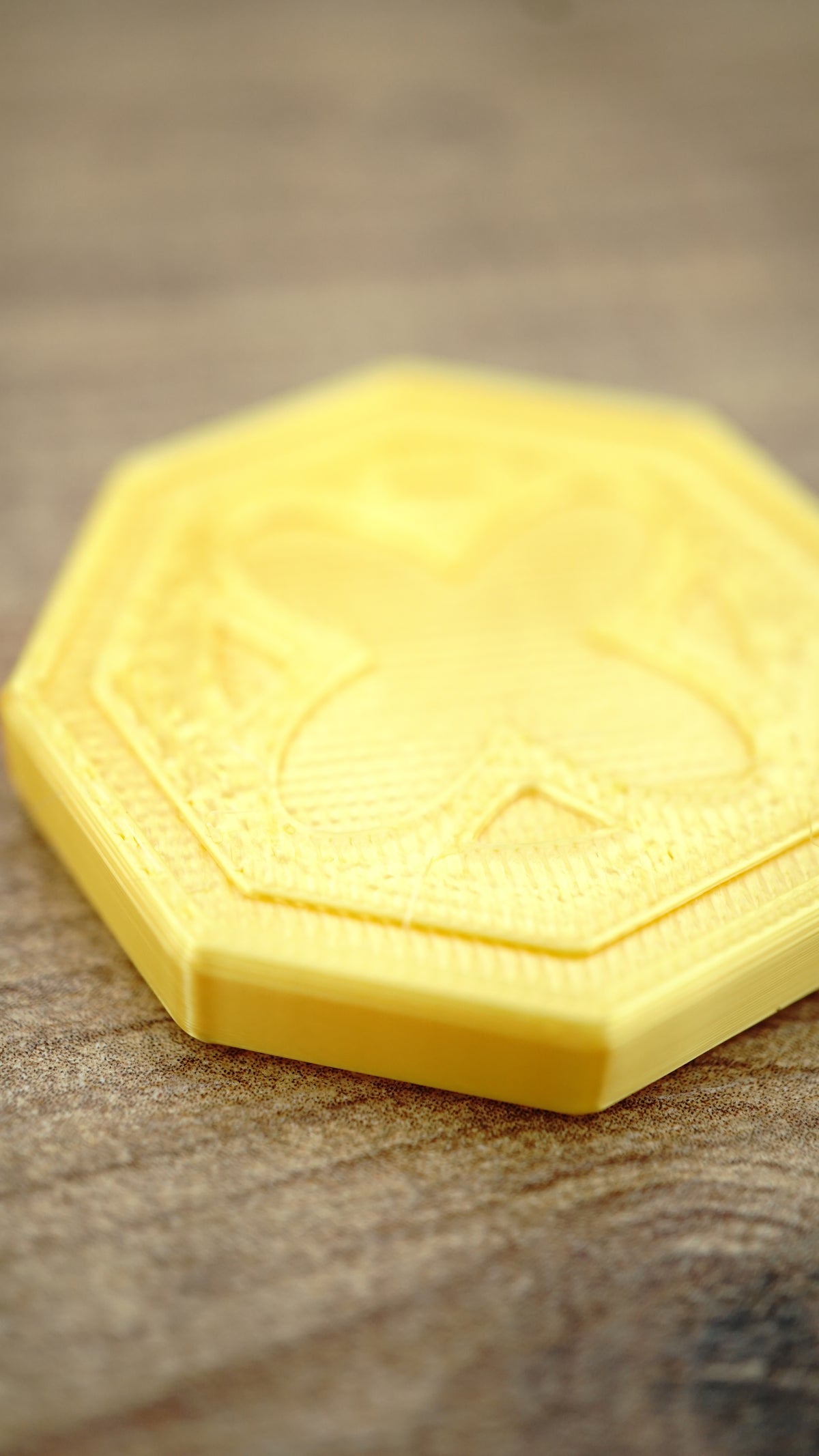 Macro close-up of an OSRS inspired gold coin highlighting the raised emblem, layered edge detail and smooth metallic-style gold surface