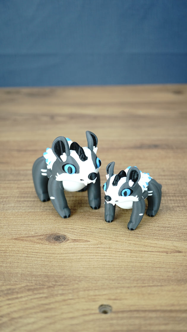 Two Bluebristle Muujin figures inspired by Palia plushies, displayed side by side in 12 cm and 9 cm sizes with bright blue eyes and white manes.
 Copy alt text