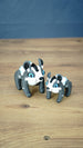Two Bluebristle Muujin figures inspired by Palia plushies, displayed side by side in 12 cm and 9 cm sizes with bright blue eyes and white manes.
 Copy alt text