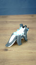 Rear view of the Palia Bluebristle Muujin collectible figure displaying its long grey and white tail, white fantasy creature mane and turquoise blue accents.