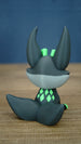 Back view of a Cave Kitsuu 3D printed figure showing its curled tail, tall ears, and bright green diamond markings on its back.