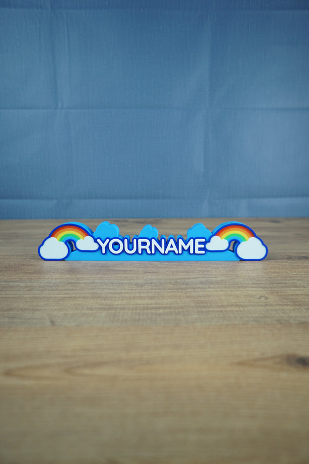 3D printed Construction Cutie nameplate inspired by Palia with rainbow and clouds