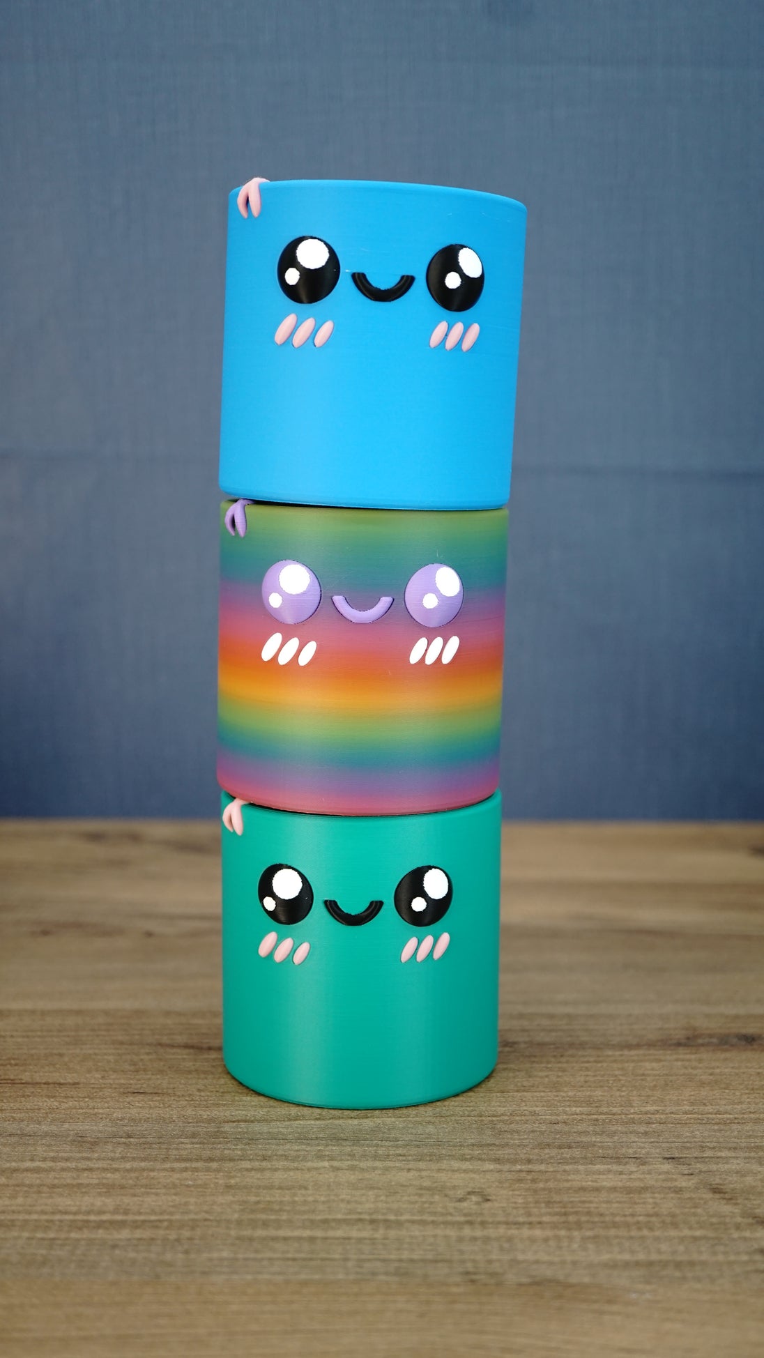 Stacked Palia Cyl Cylinder Collectibles showing the blue, rainbow, and green color versions.