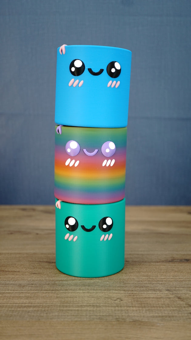Stacked Palia Cyl Cylinder Collectibles showing the blue, rainbow, and green color versions.