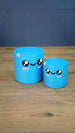 Large and small blue Palia Cyl Cylinder Collectible figures with kawaii faces and pink cheek details.