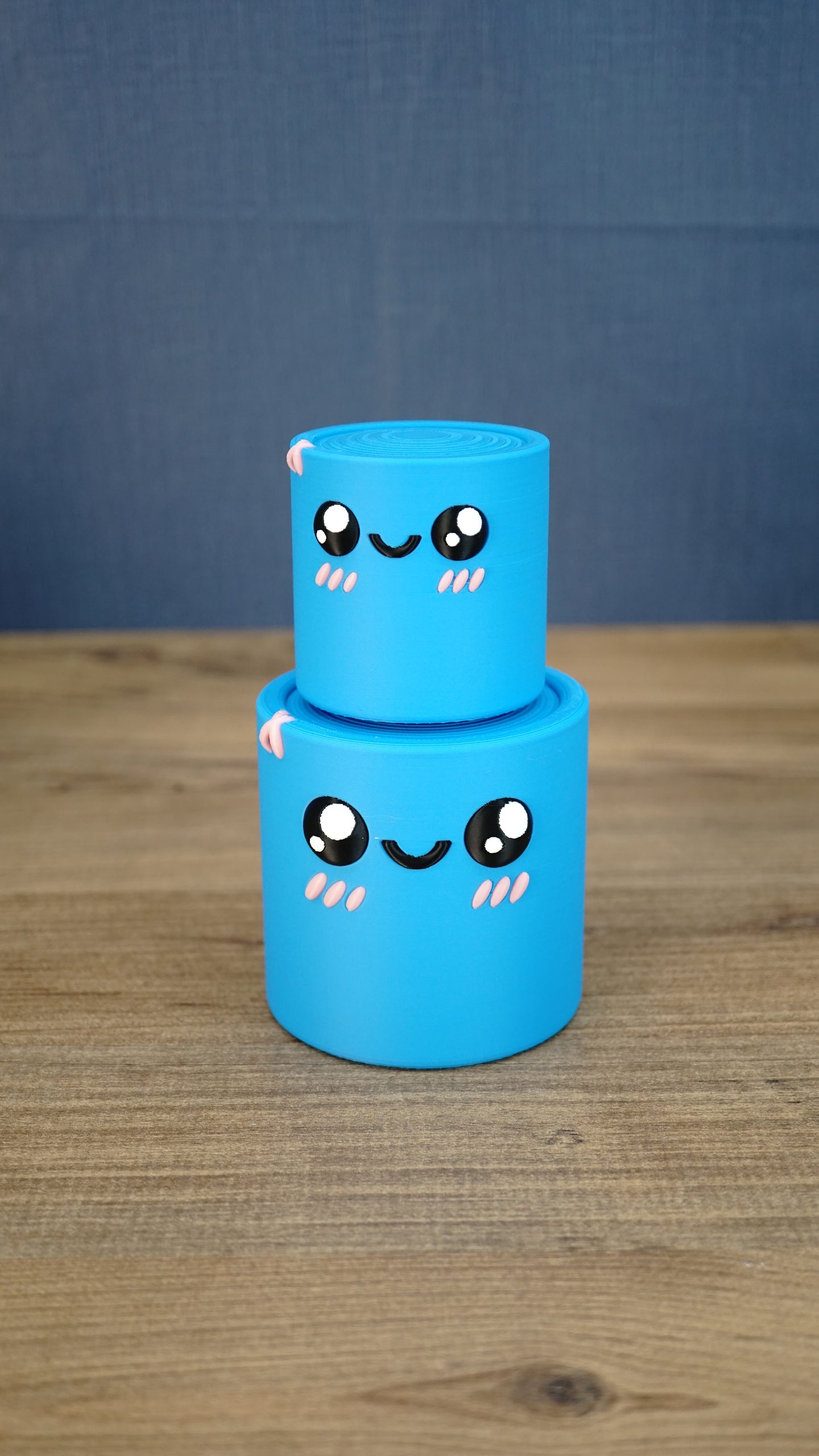 Small blue Palia Cyl Cylinder Collectible stacked on top of the larger blue version.