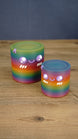 Large and small rainbow Palia Cyl Cylinder collectibles displayed together on a wooden tabletop.