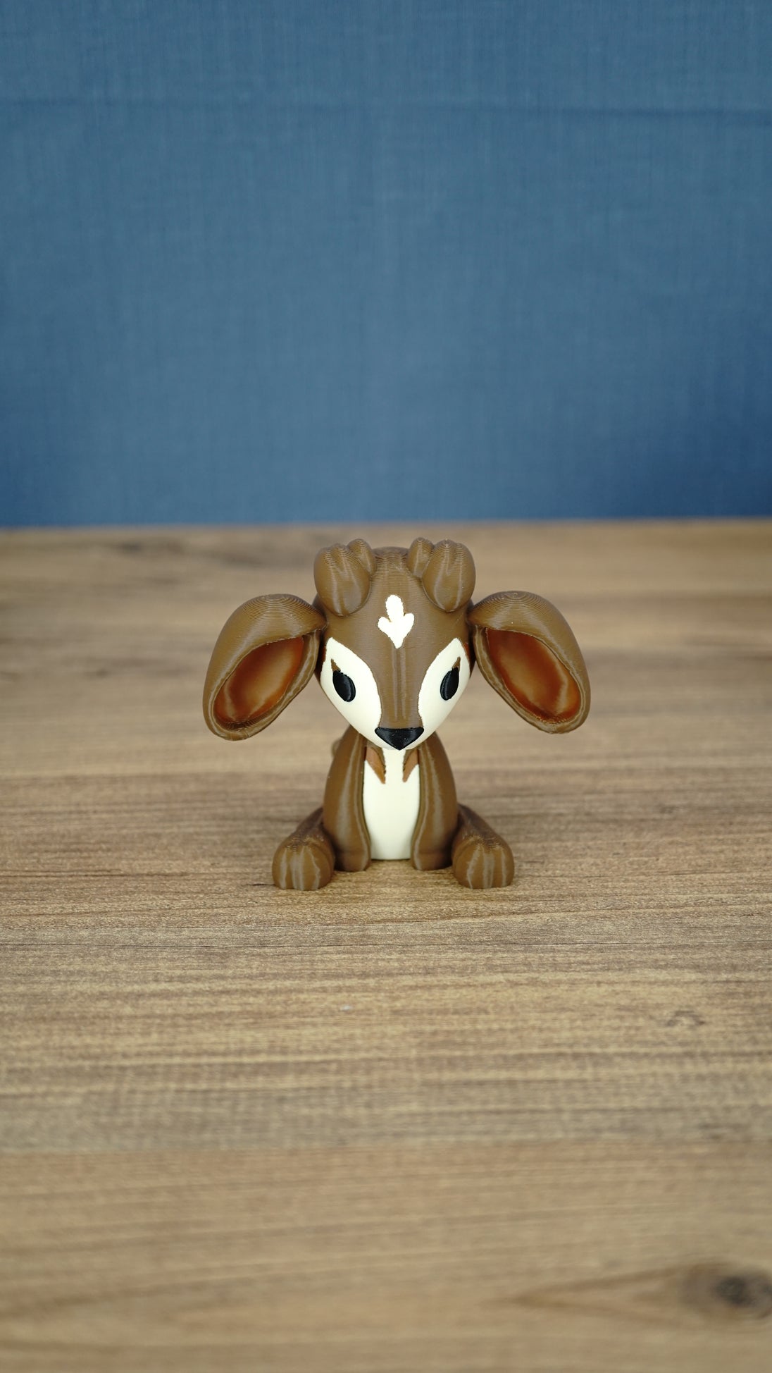 Elder Sernuk-inspired Palia plush figure shown from the front on a wooden tabletop.