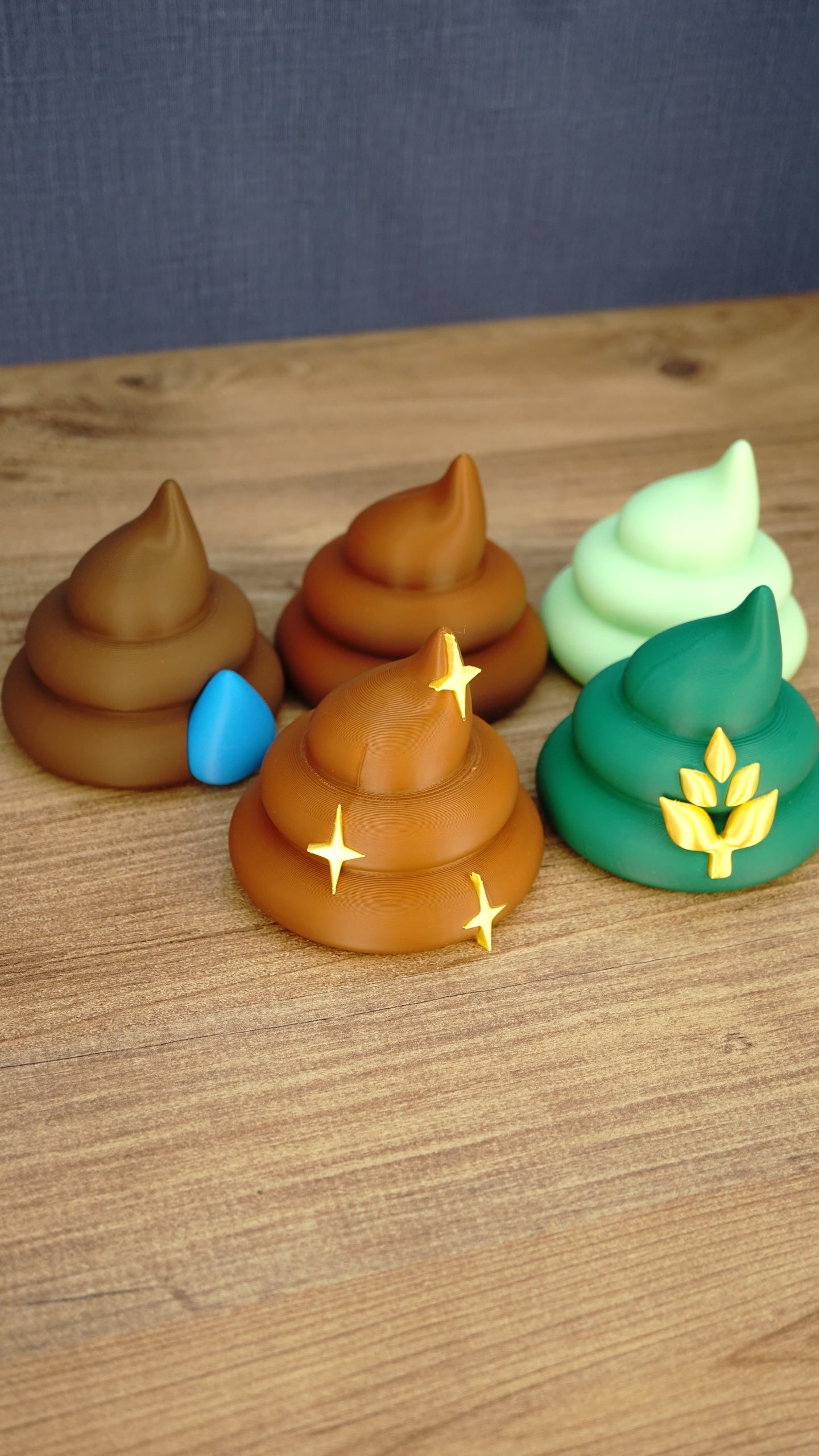Palia-inspired fertilizer collectible set showing five colourful designs including brown, green and pale green figures with decorative details.