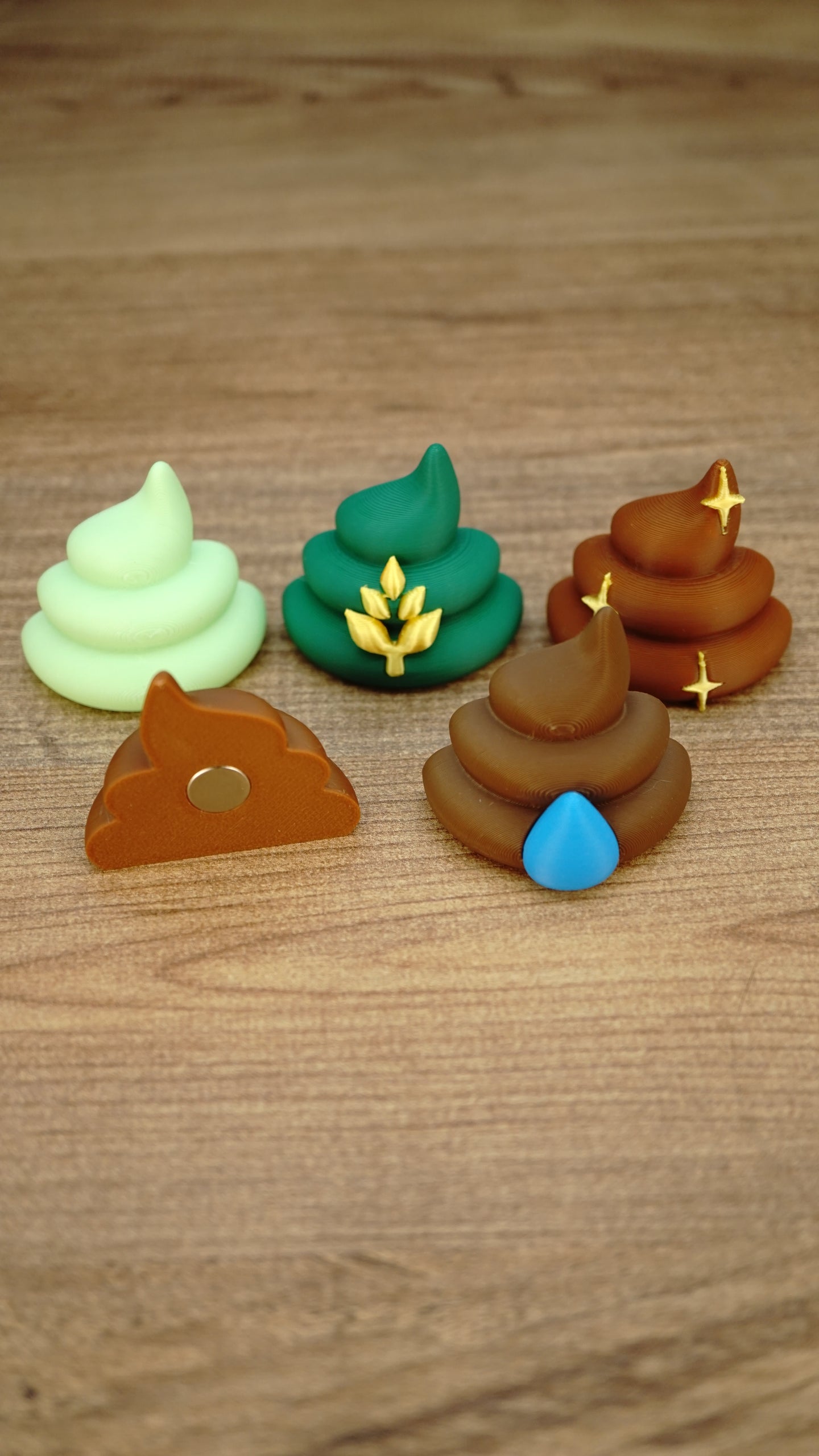 Palia fertilizer figures and magnets displayed together, showing the five available designs plus the round magnet fitted to the back of one collectible.