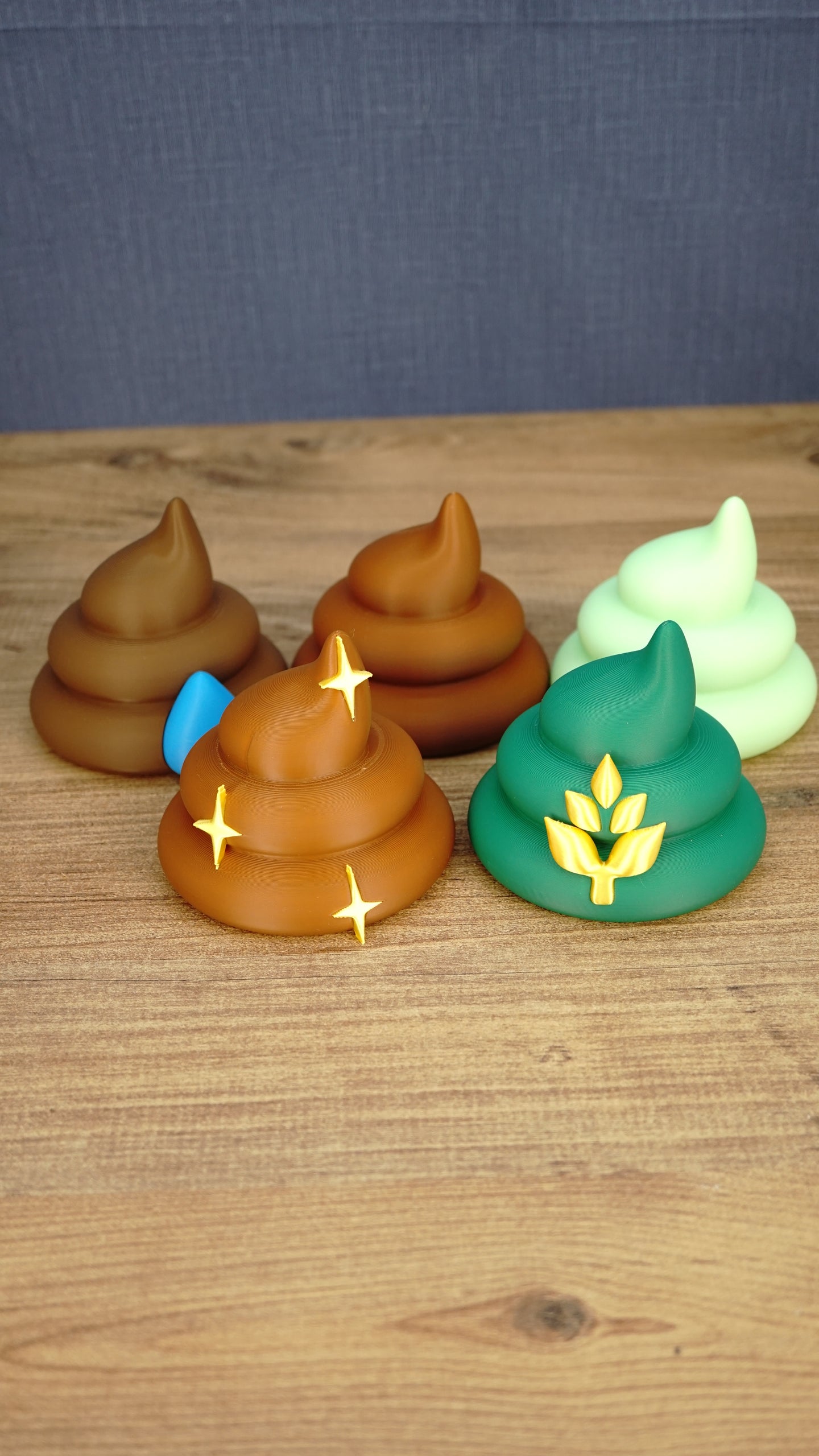Collection of five Palia fertilizer figures and magnets featuring HarvestBoost, HydratePro, QualityUp, SpeedyGro and WeedBlock designs on a wooden surface.