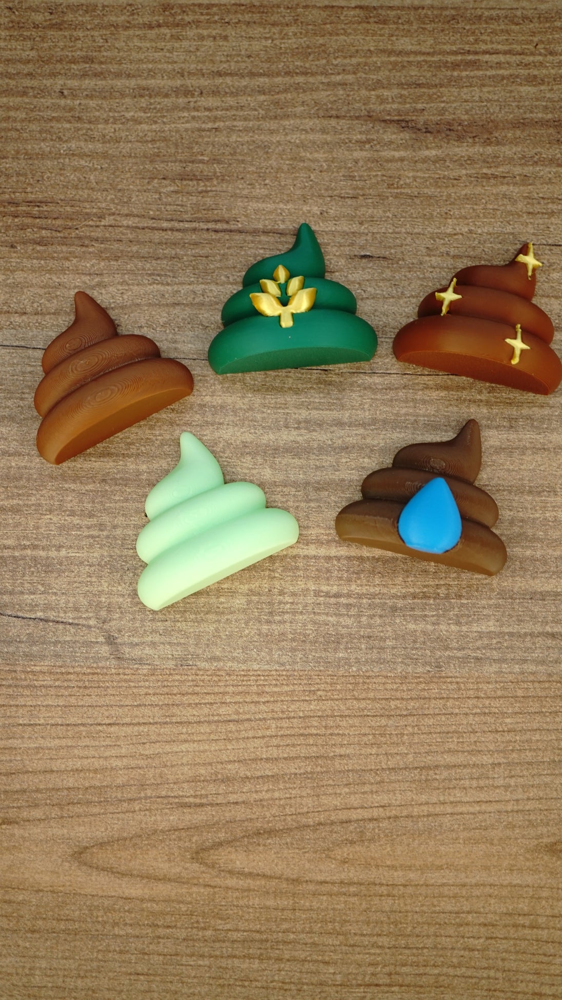 Five Palia fertilizer magnet designs arranged on a wooden surface, including WeedBlock, QualityUp, SpeedyGro, HydratePro and HarvestBoost styles.