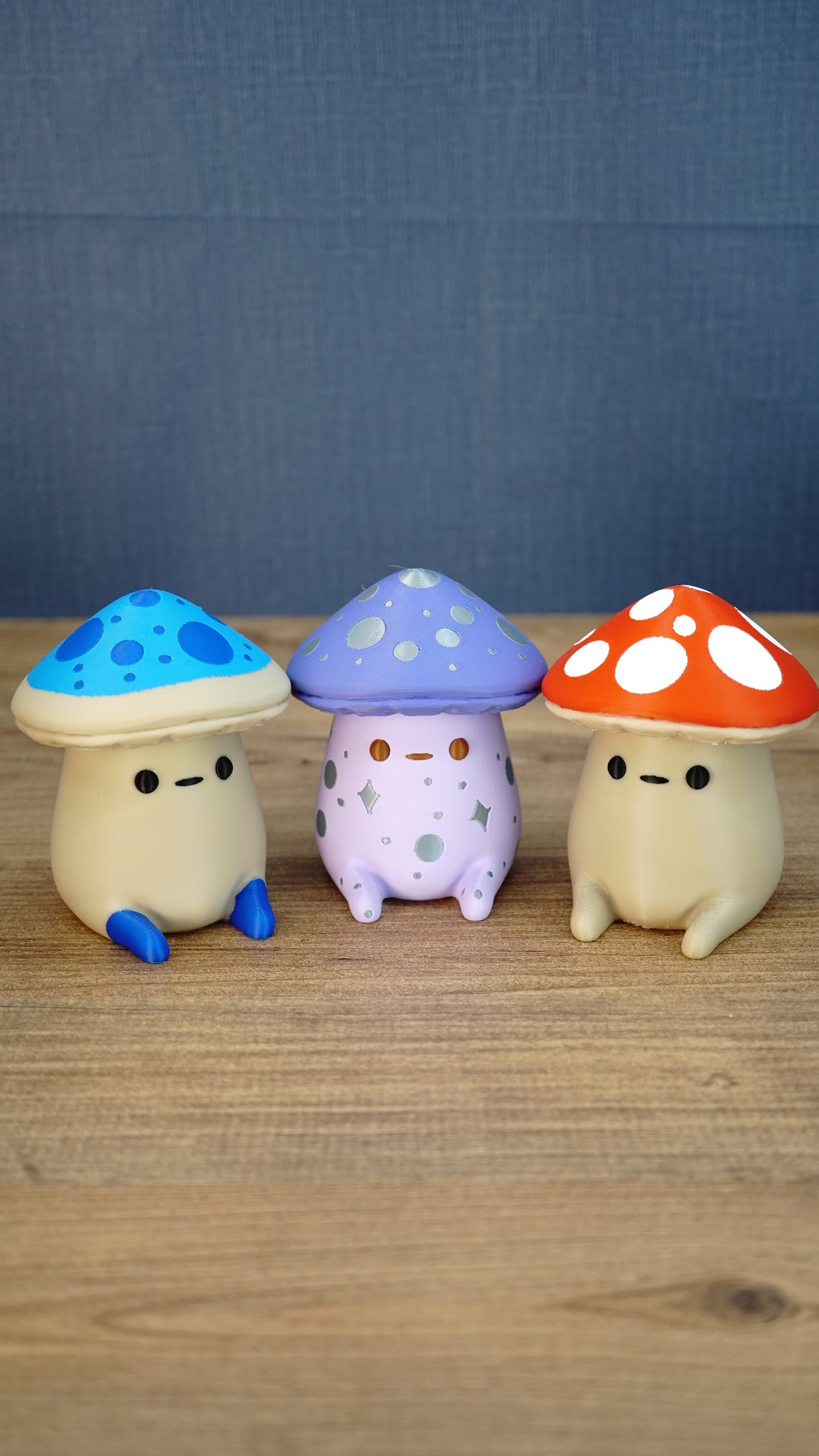 Three Palia Fun Guy 3D printed figurines displayed together, including Elderwood blue, Madrinas purple, and original red mushroom designs.