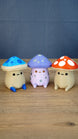 Three Palia Fun Guy 3D printed figurines displayed together, including Elderwood blue, Madrinas purple, and original red mushroom designs.