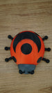 Top view of the Palia Garden Ladybug Plush collectible showing its distinctive red shell, large black wing markings, central spot and six black legs.