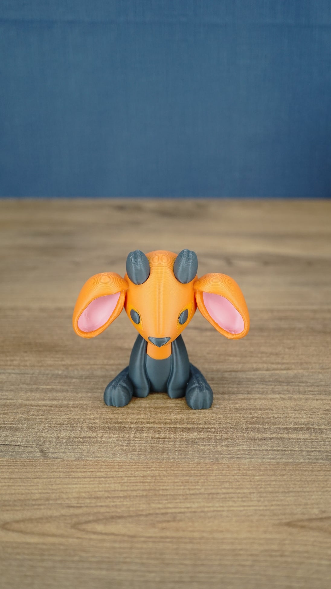 Front view of the Golden Sernuk-inspired plush figure sitting on a wooden tabletop.