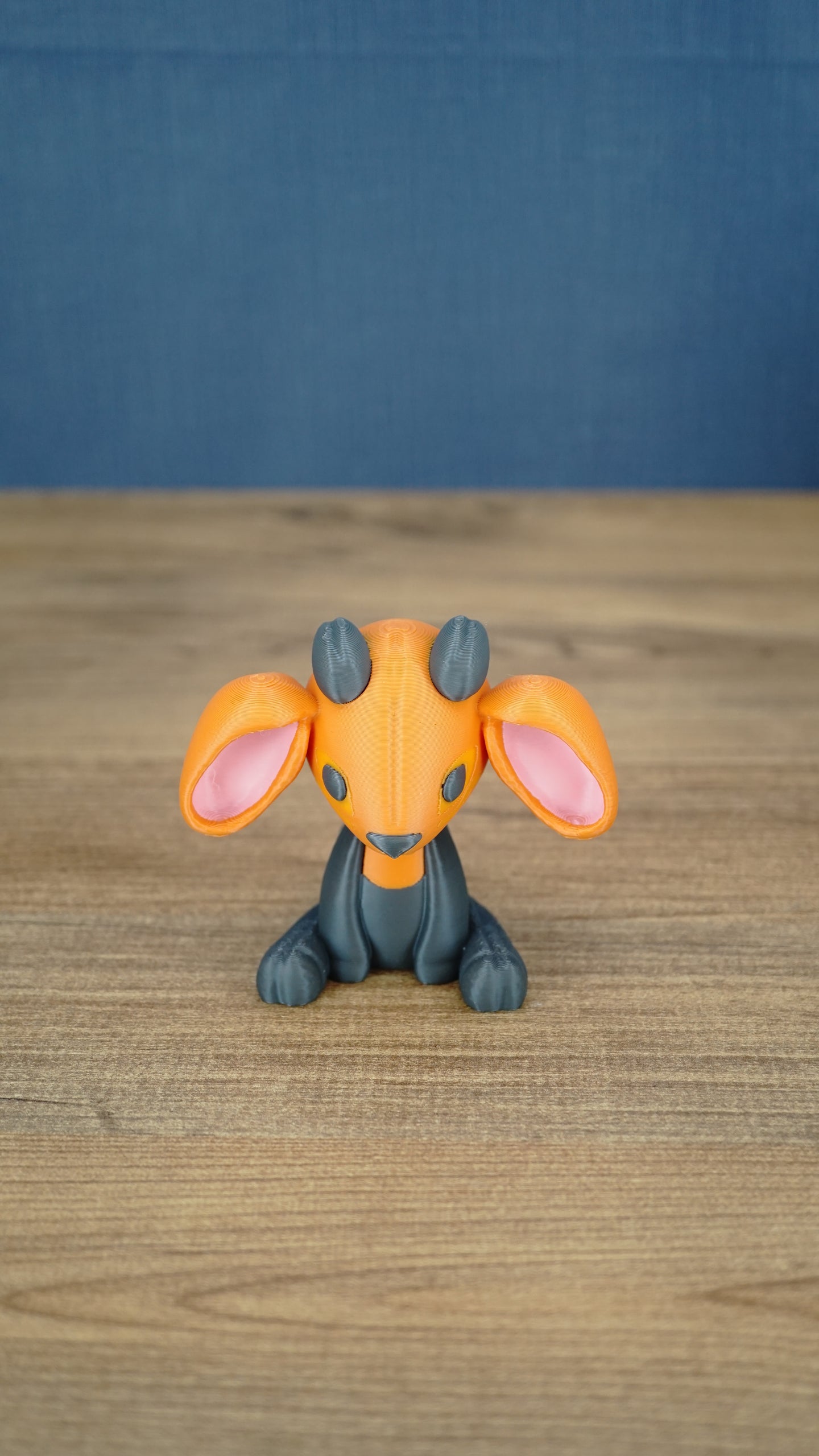 Front view of the Golden Sernuk-inspired plush figure sitting on a wooden tabletop.