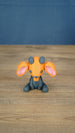 Front view of the Golden Sernuk-inspired plush figure sitting on a wooden tabletop.