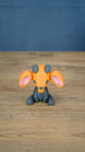 Front view of the Golden Sernuk-inspired plush figure sitting on a wooden tabletop.