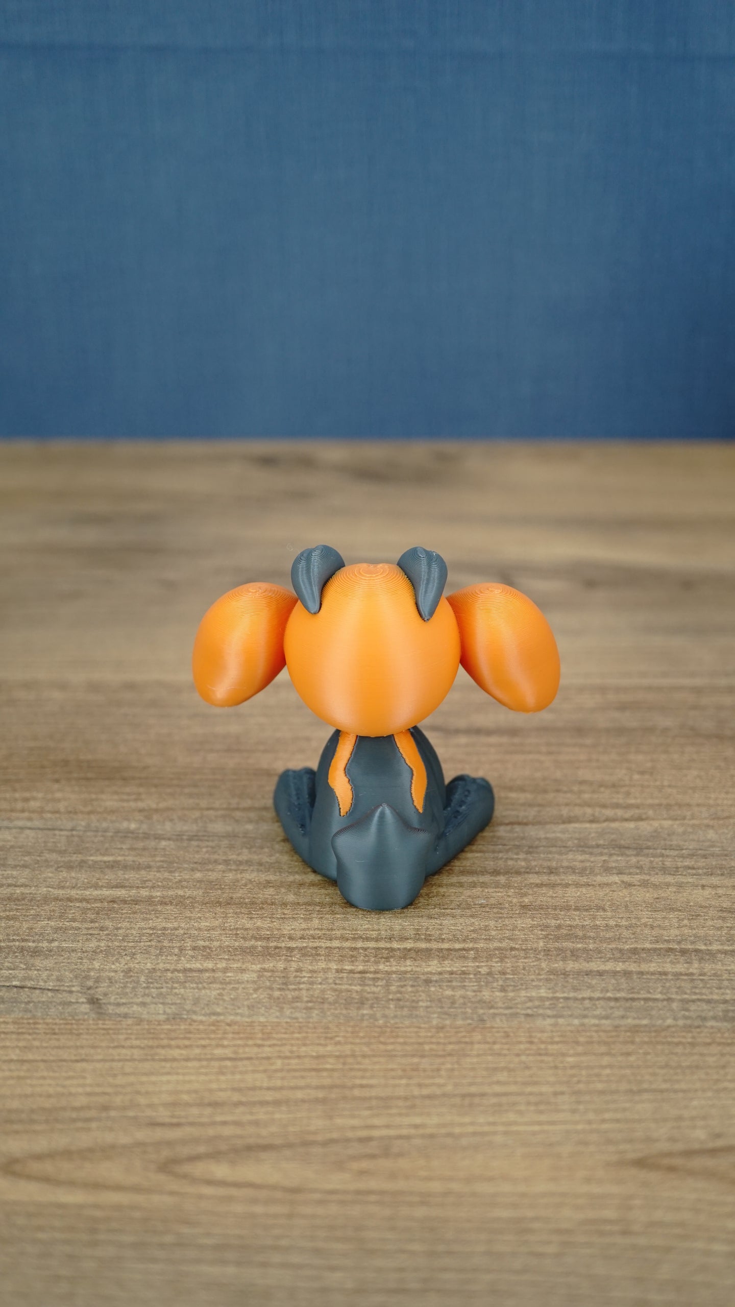 Rear view of the Golden Sernuk-inspired plush figure showing gray body details and rounded tail.