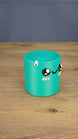 Angled view of the Palia Green Cylinder plush showing its rounded cylinder shape, spiral top texture, and kawaii face details.