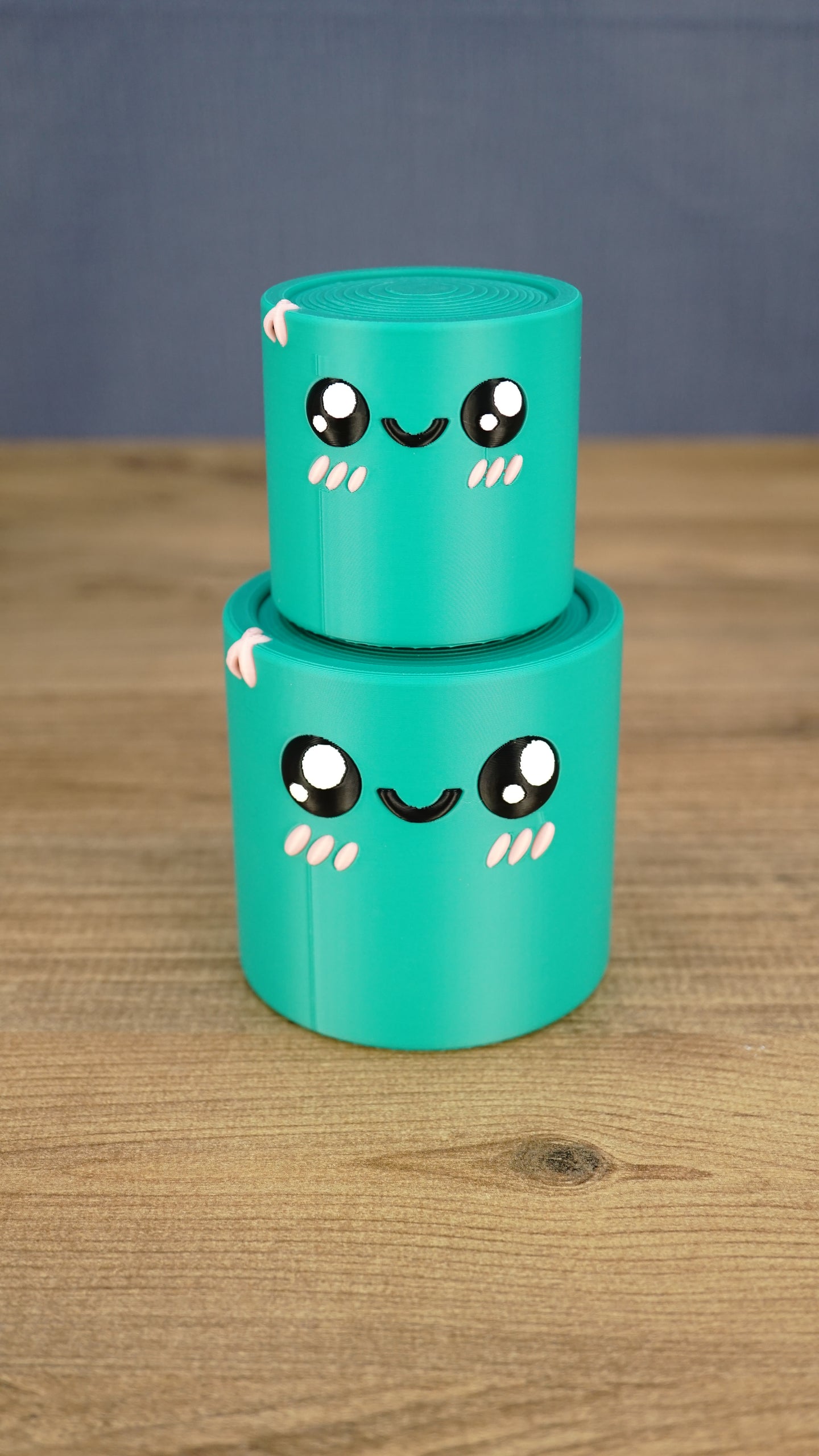 Small teal Palia Green Cylinder plush stacked on top of the larger size, showing both 3D printed size options.