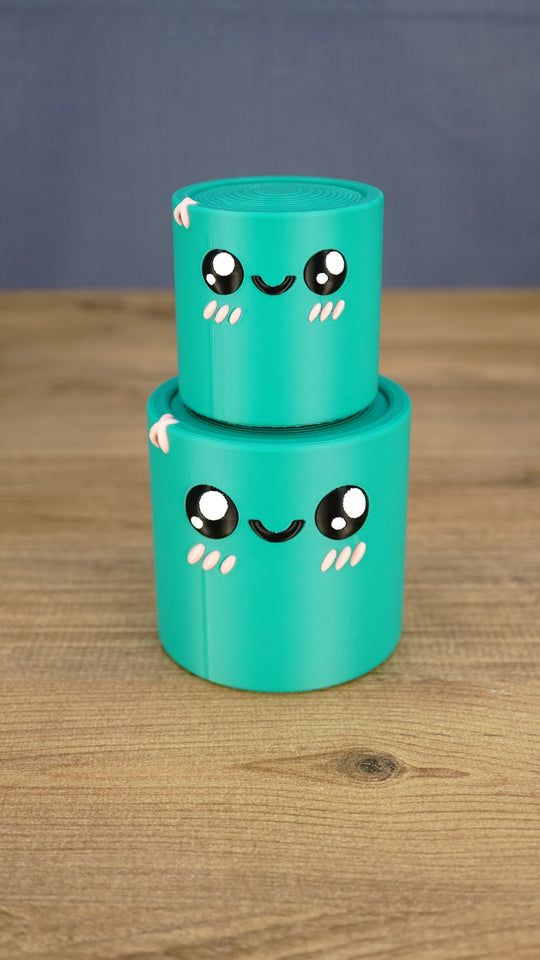 Small teal Palia Green Cylinder plush stacked on top of the larger size, showing both 3D printed size options.