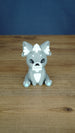 Front view of a grey 3D printed Palcat plush figure with white ear tufts, black eyes, white chest detail, and light blue paw pads.