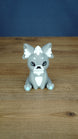 Front view of a grey 3D printed Palcat plush figure with white ear tufts, black eyes, white chest detail, and light blue paw pads.