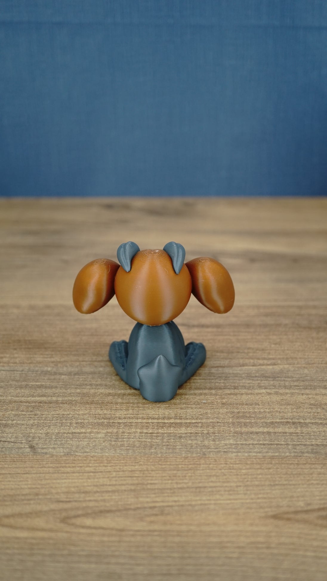 Rear view of the Highlands Sernuk-inspired plush figure showing its blue head and light tail detail.