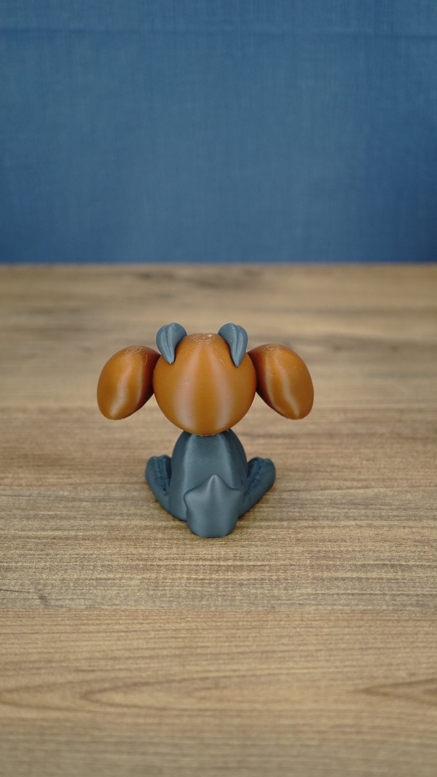 Rear view of the Highlands Sernuk-inspired plush figure showing its blue head and light tail detail.