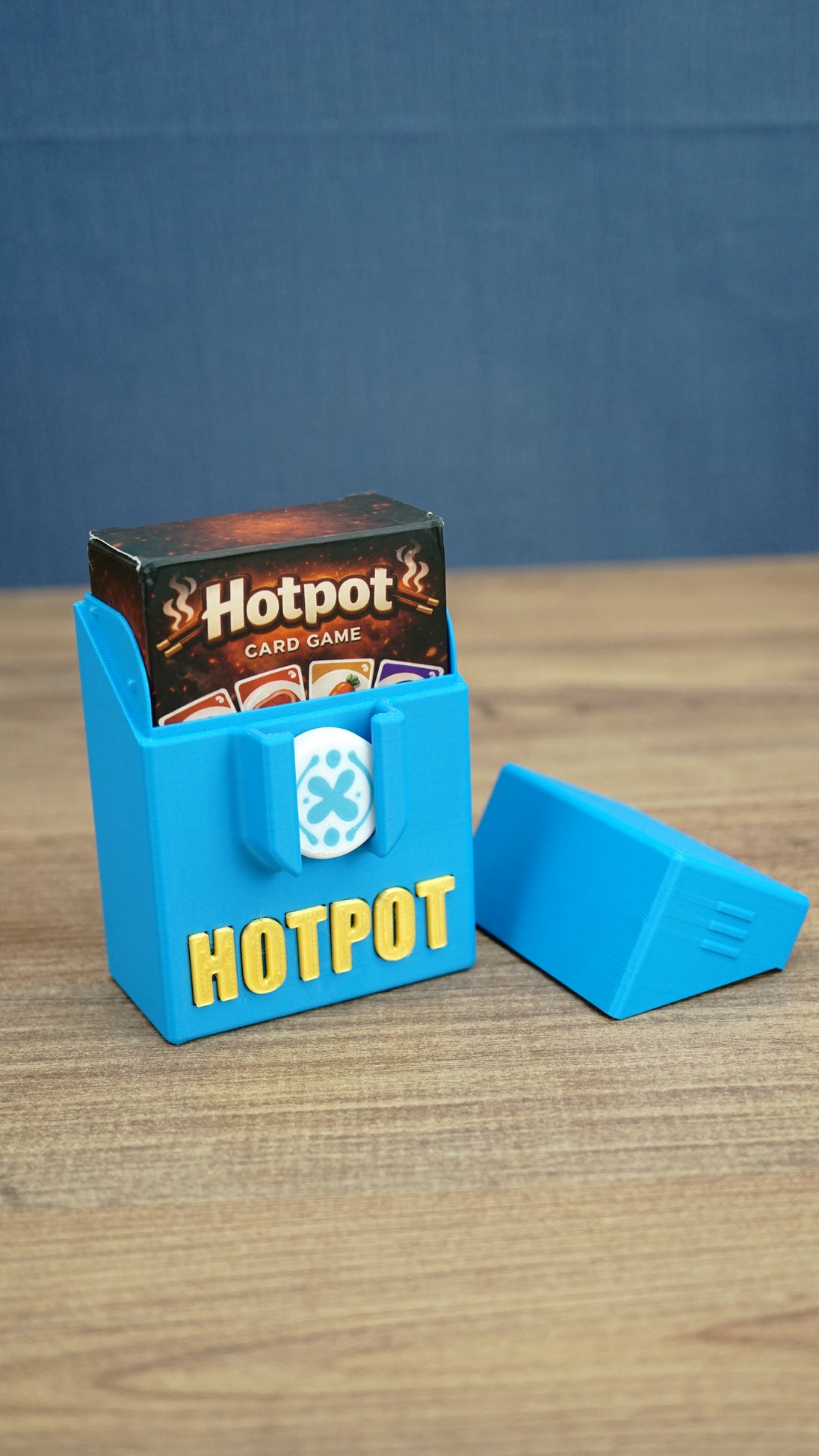 Open blue Palia Hotpot storage box holding the mini card game box, with the removable lid placed beside it.