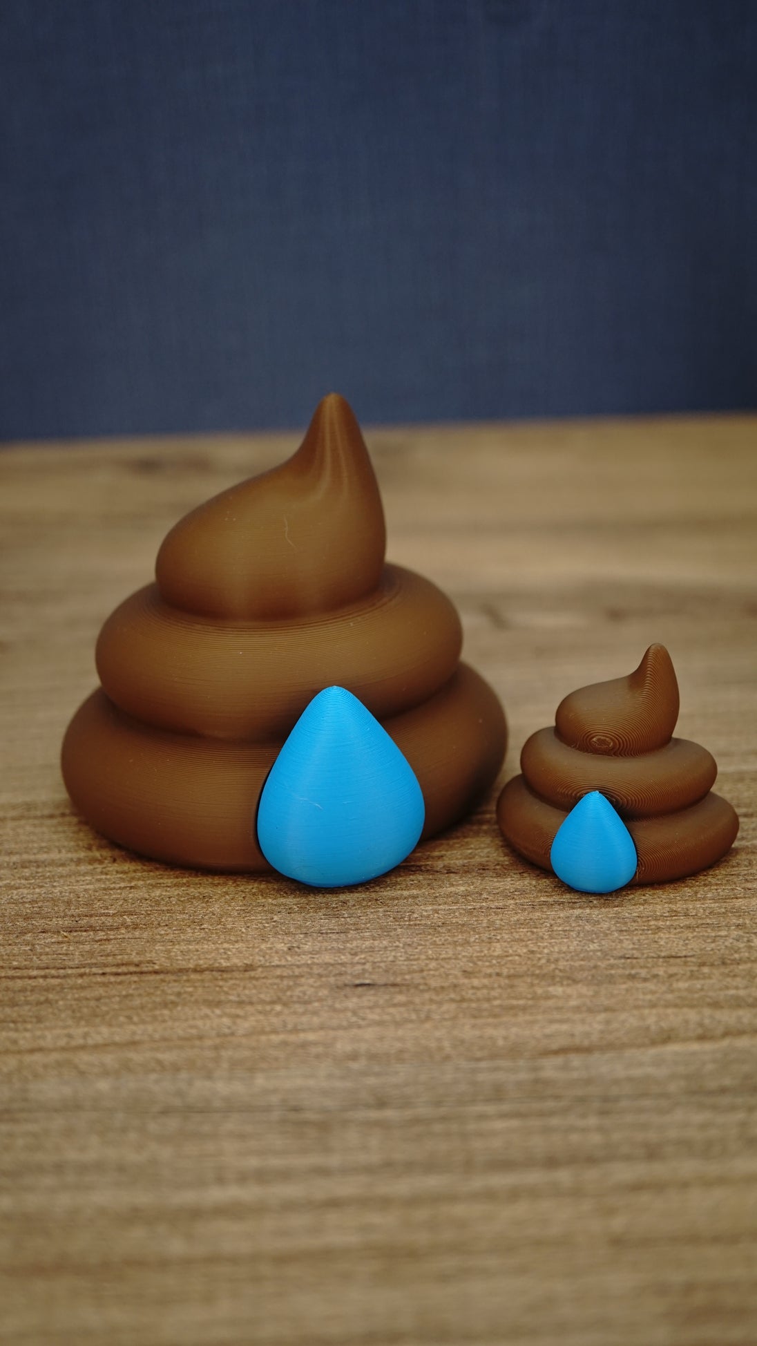 Large and small HydratePro Palia fertilizer collectibles in brown with bright blue water-drop details, showing figure and magnet size styles.