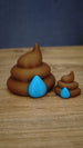 Large and small HydratePro Palia fertilizer collectibles in brown with bright blue water-drop details, showing figure and magnet size styles.