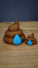 Large and small HydratePro Palia fertilizer collectibles in brown with bright blue water-drop details, showing figure and magnet size styles.