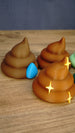 Close-up of Palia-inspired HydratePro fertilizer with blue water drop and QualityUp fertilizer with gold sparkle decorations alongside other designs.