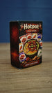 Angled view of the Palia-inspired Hotpot card game box showing the illustrated front design, ingredient cards, and dark red side panel.